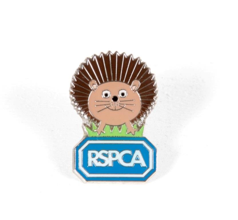 A hedgehog and RSPCA logo metal pin badge.