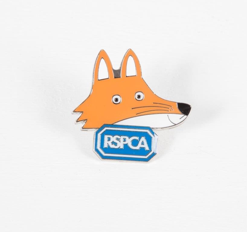 A fox and RSPCA logo metal pin badge against a white background.