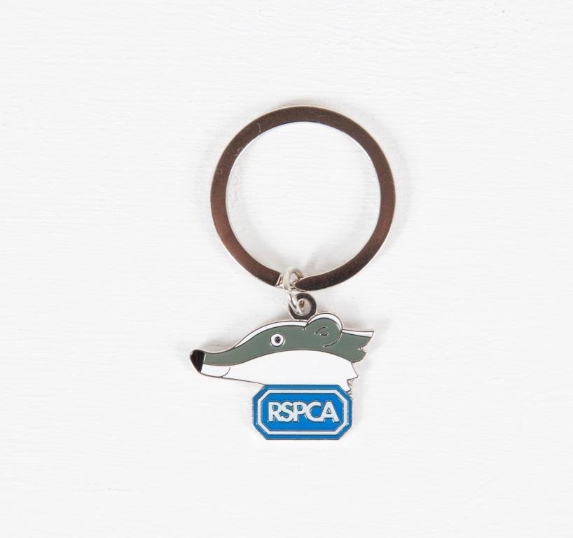A metal badger keyring with the RSPCA logo.