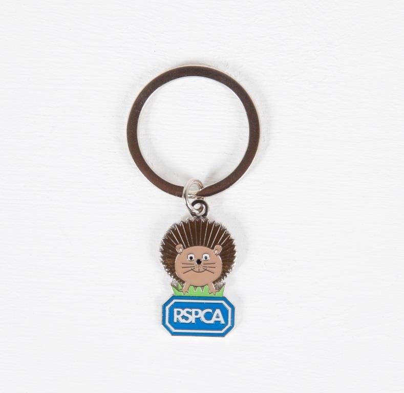 A metal hedgehog and RSPCA logo keyring.