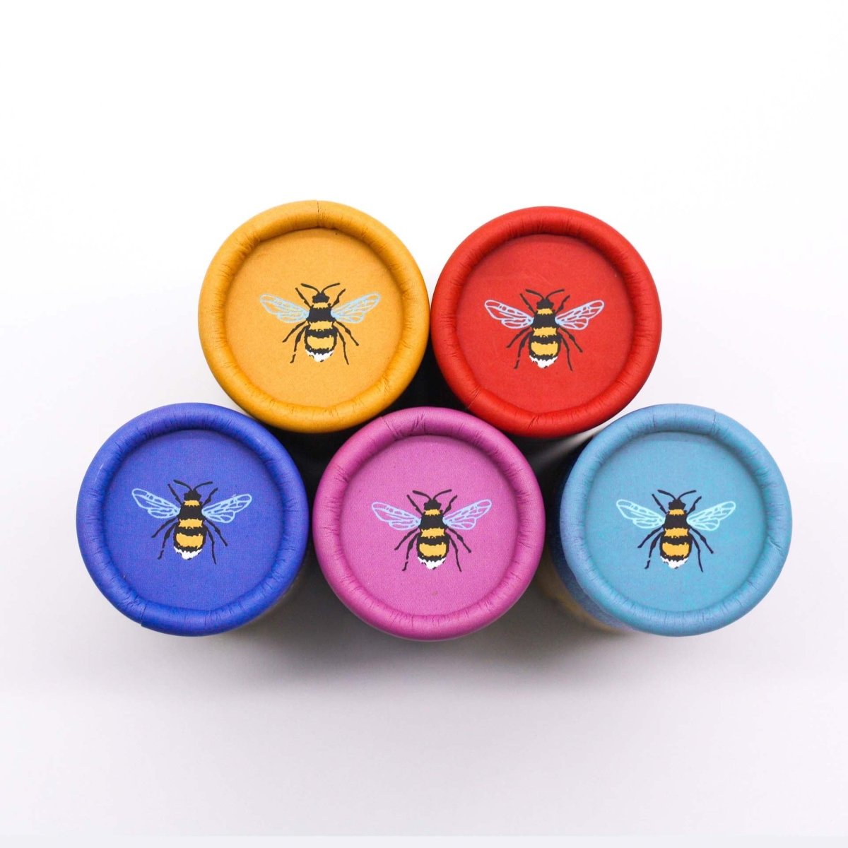 Collection of different coloured tubes, with a bumblebee logo on the lid.