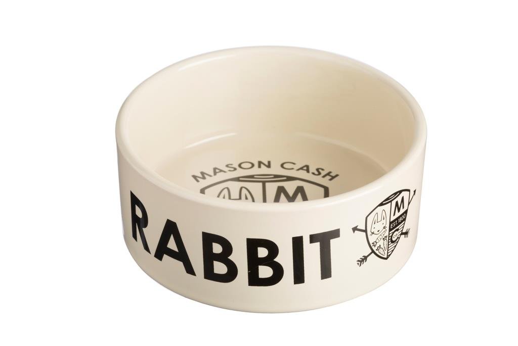 A cream coloured stoneware rabbit bowl with the word rabbit written on the side and a coat of arms design inside the bowl with the RSPCA logo.