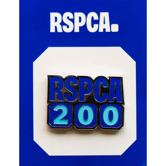 An RSPCA 200th anniversary metal pin badge against a white and blue background. 