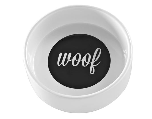 A white ceramic dog bowl with the wording woof written in black on the inside.