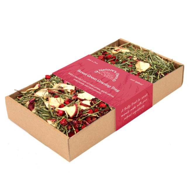 A glazing tray in cardboard packaging with a blended mix of dried apple slices, rose petals and redcurrants inside.