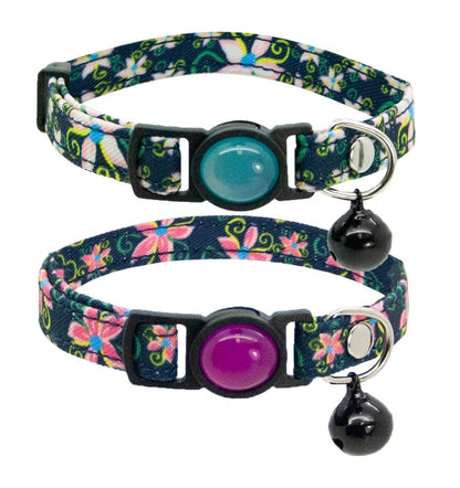 Two cat safety collars featuring a denim floral design. One tag has a blue gem and the other has a purple gem.