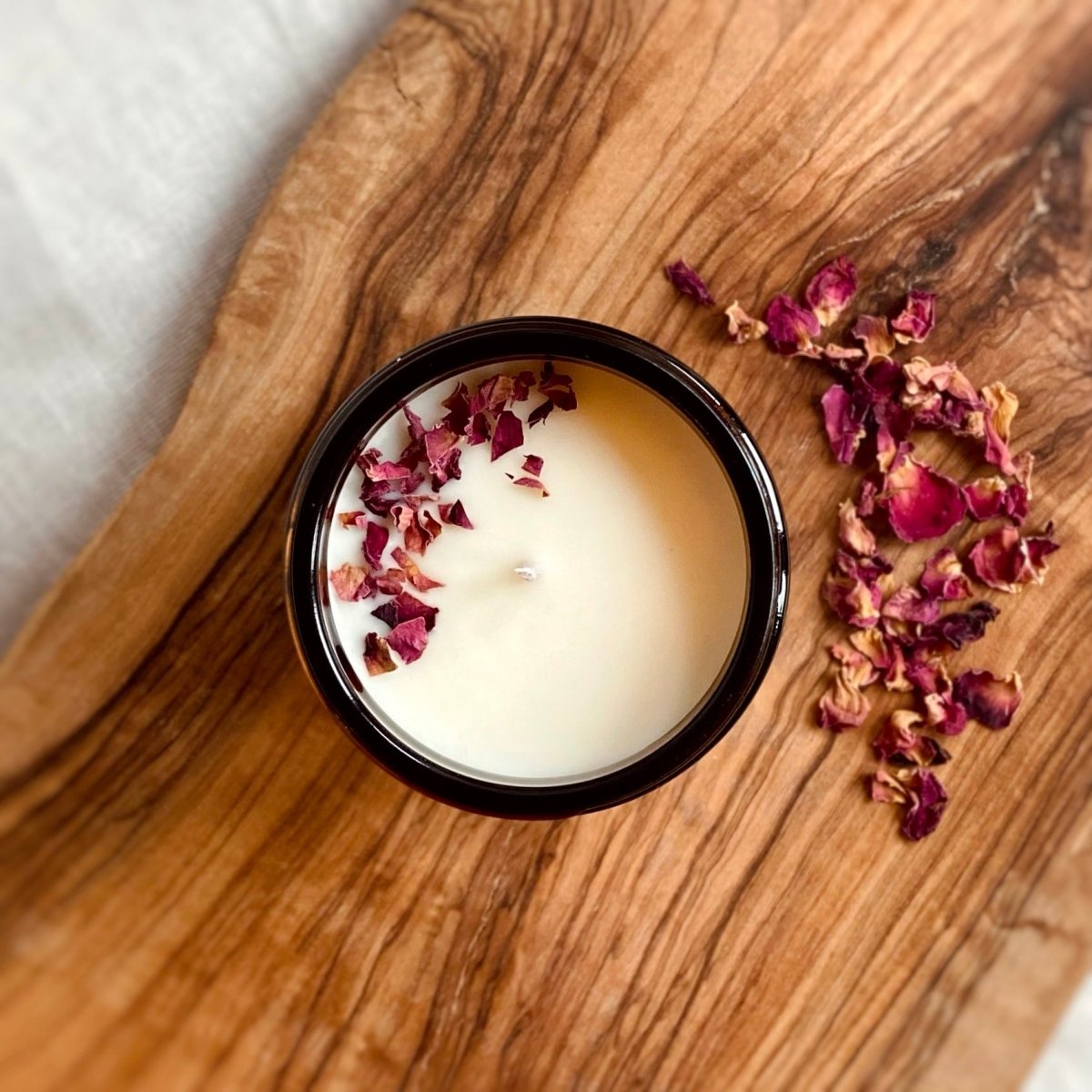 A view of the candle from above.  The candle is filled with dry rose petals. 