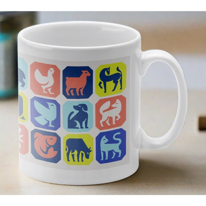 A white mug embossed with colourful animal graphics. 