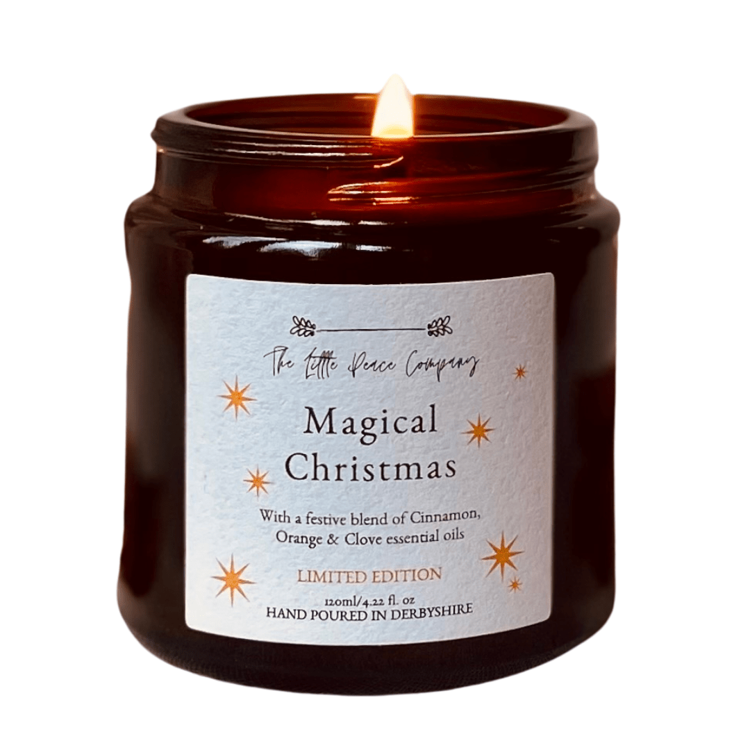 A Magical Christmas scented candle in a brown glass jar, against a white background.