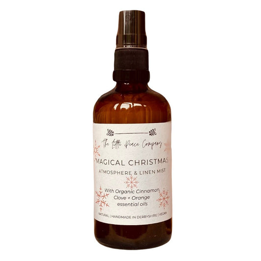 A magical christmas scented atmosphere and linen mist in a brown glass jar with a decorative label. 